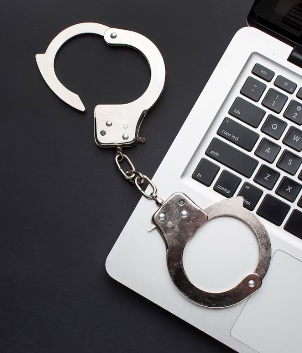 flat-lay-handcuffs-with-laptop-copy-space handcuffs and money on the table